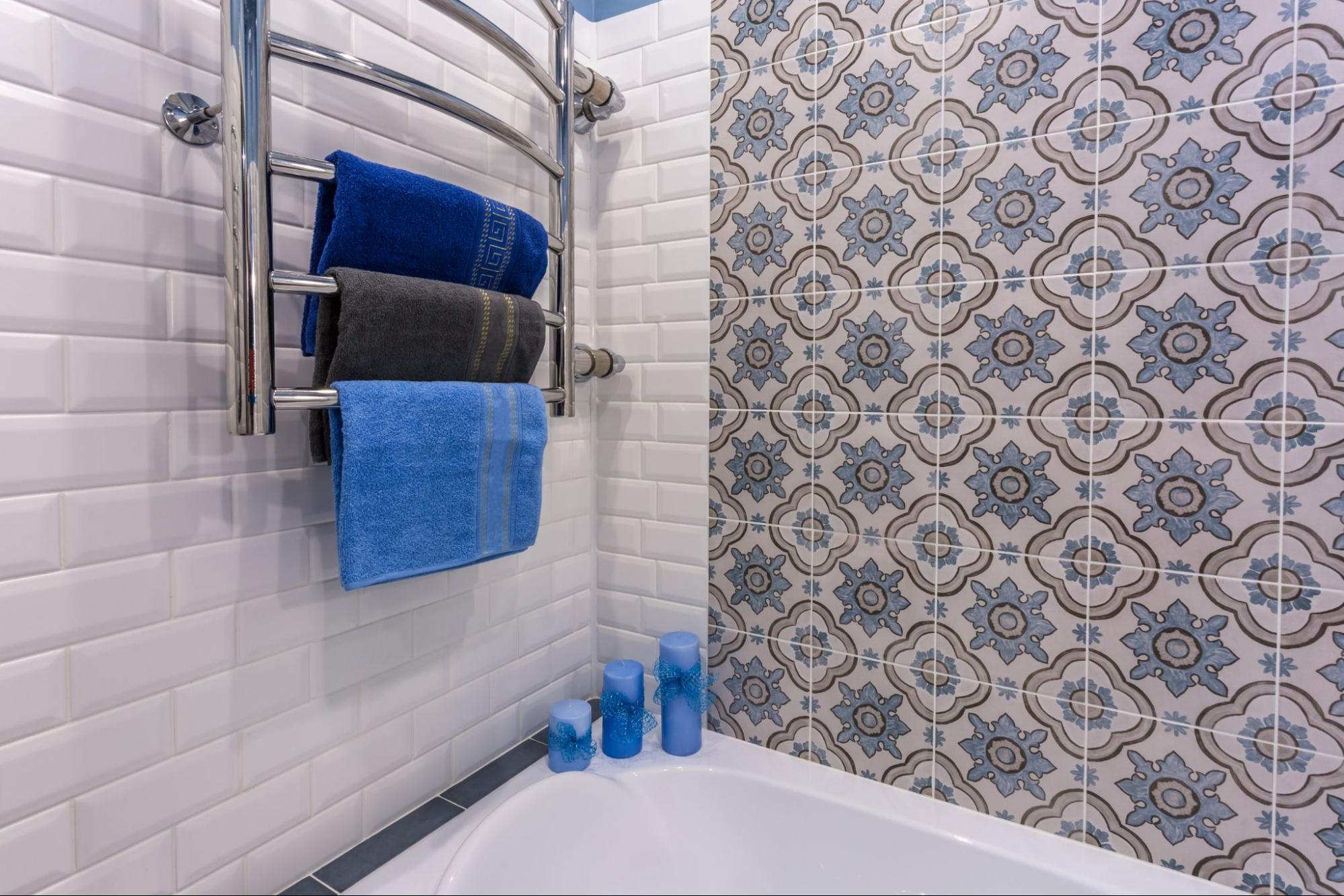 A modern bathroom featuring a mix of neutral-toned and decorative tiles.