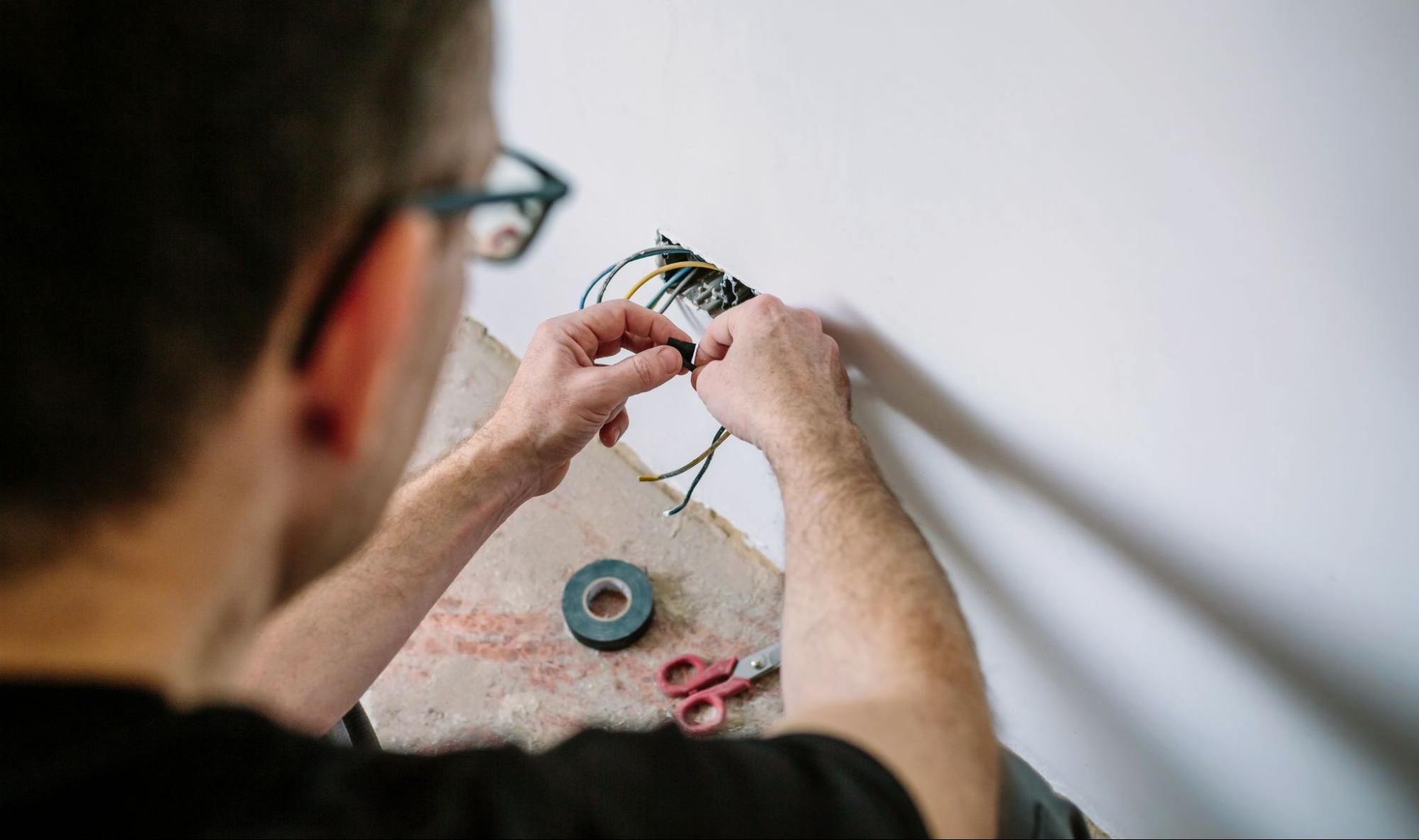 Electrician setting up wiring in a newly built house