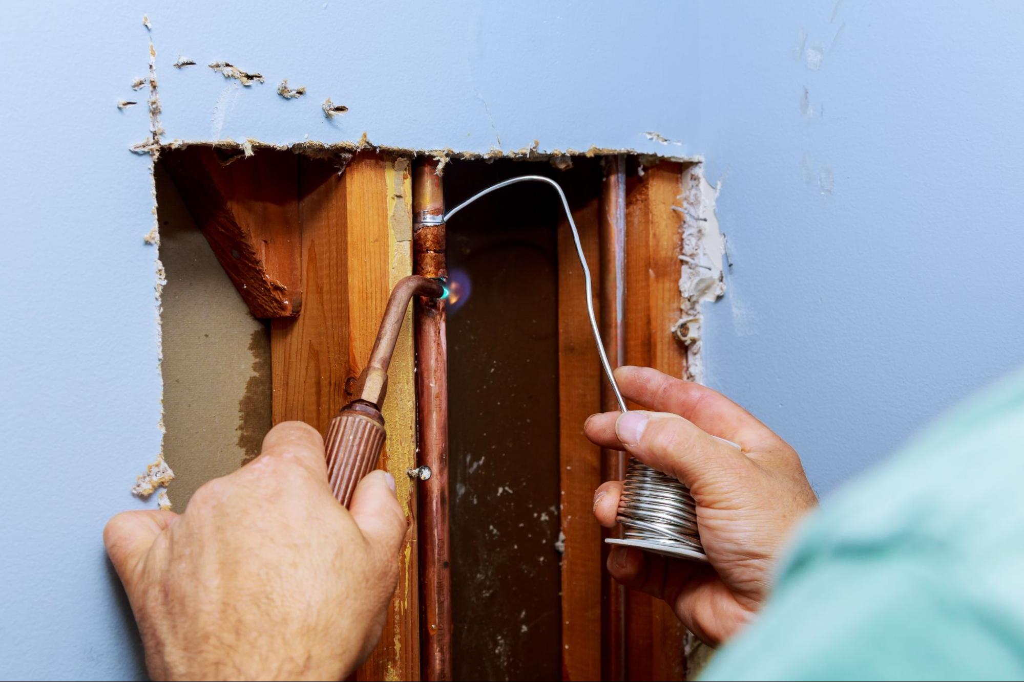 Ongoing plumbing repair service on exposed wall pipes